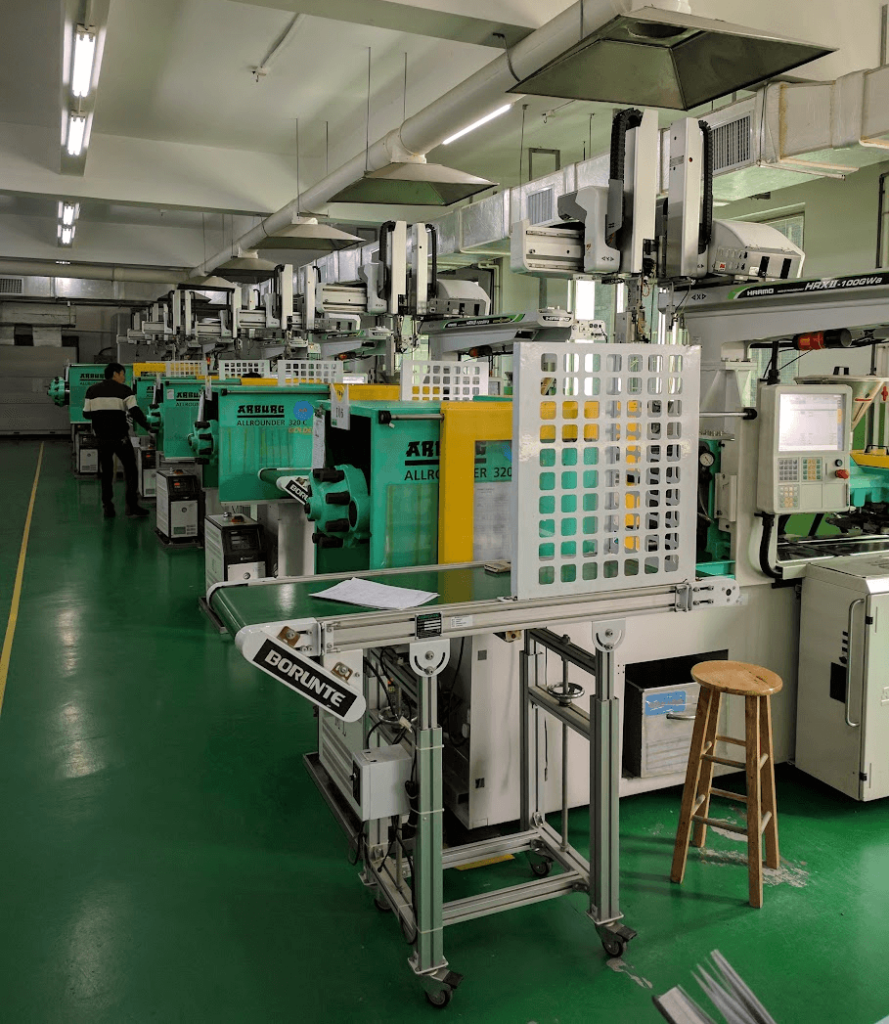 A typical injection molding shop with robotic arms.